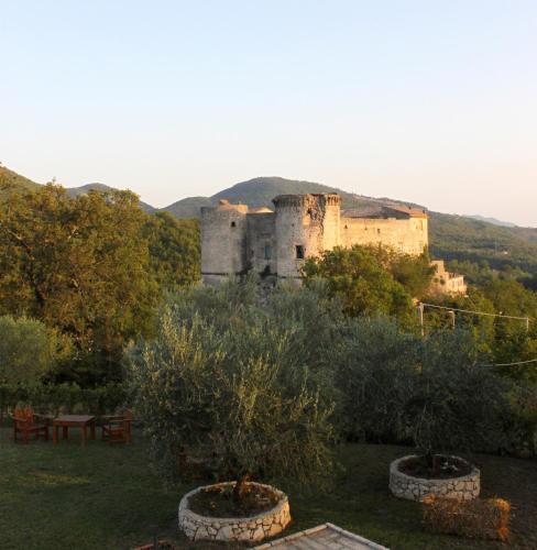 a castle sitting on top of a hill with trees at Masseria Mastrangelo in Prata Sannita