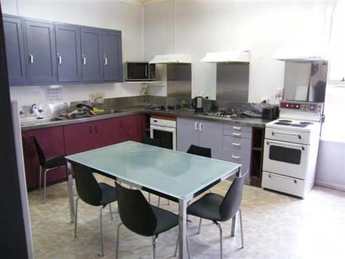 a kitchen with a table and chairs in it at Ballymena House in Dunedin