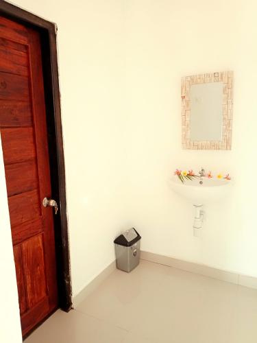 a bathroom with a sink and a mirror at Japa Bungalow in Nusa Penida