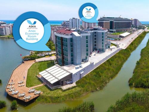 an aerial view of a resort on a river with buildings at Aska Lara Resort & Spa Hotel in Lara