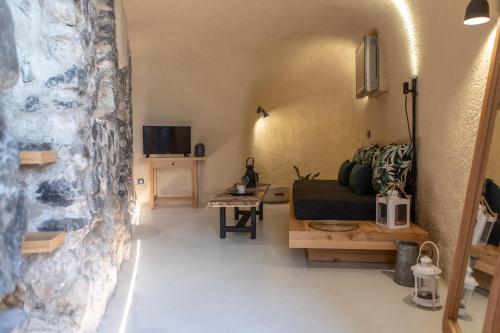 a living room with a couch and a table at Nalas Suites in Emporio Santorini