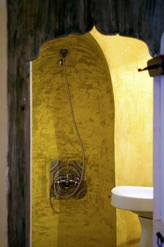 a yellow bathroom with a sink and a toilet at Hotel Dar Dhiafa in Houmt Souk