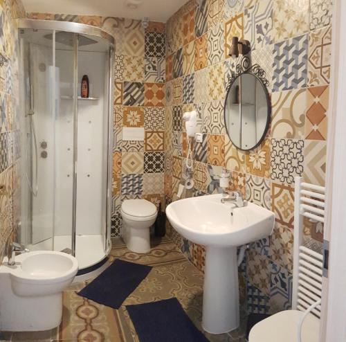 ein Bad mit einem Waschbecken, einem WC und einer Dusche in der Unterkunft B&B Maricentro in Taranto