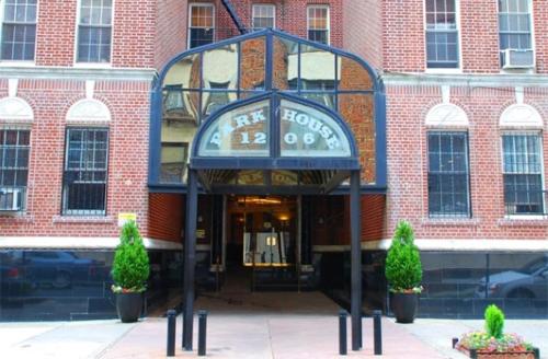 a hotel sign in front of a brick building at Park House Hotel Brooklyn in Brooklyn