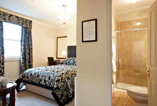 a bedroom with a bed and a bathroom with a shower at Bronte Guest House in York