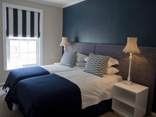 A bed or beds in a room at Kenjockity Self Catering Apartments
