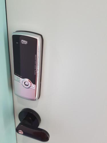 a cell phone sitting on top of a shelf at Seoul Forest Stay in Seoul