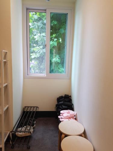 a room with two tables and a window at Seoul Forest Stay in Seoul