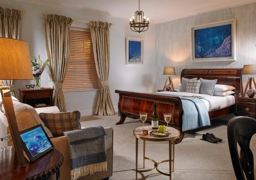 a hotel room with a bed and a table with wine glasses at The Blue Haven Hotel in Kinsale