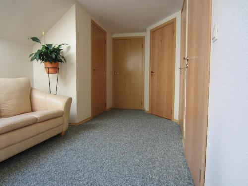 a living room with a couch and a potted plant at Hostel Livonija in Sigulda