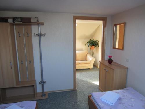 a room with a bedroom with a bed and a couch at Hostel Livonija in Sigulda