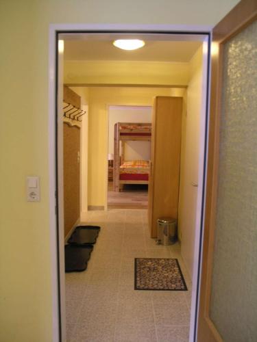 a hallway with a hallway leading to a room at Pension Edelweiss Top21 in Gosau