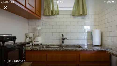 a kitchen counter with a sink and a mixer at Calle Hollanda 1 Bedroom Home in San Juan