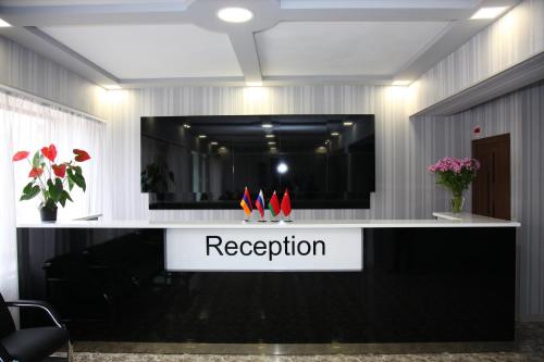 a reception desk with a sign that reads reception at Hotel Felisa Gyumri in Gyumri