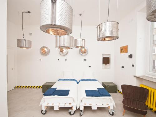 a hospital room with two beds and lights at Loft Lot Pszczoły in Warsaw