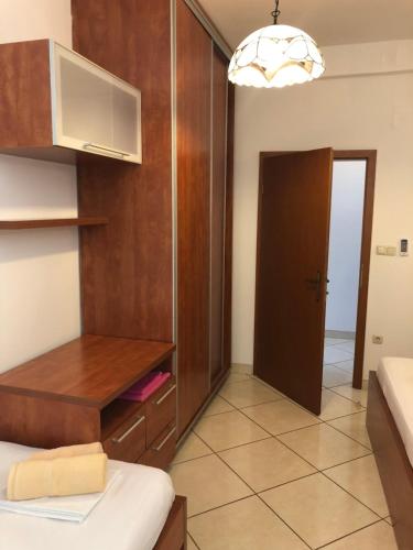 a small room with a bed and a cabinet and a door at Sea view Apartment, Todorovic in Kotor