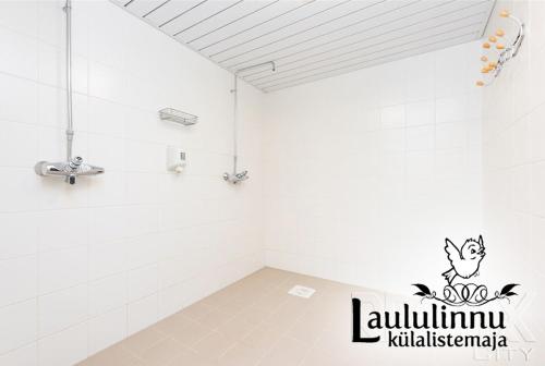 a bathroom with a cat sticker on the wall at Laululinnu Guesthouse in Järvajõe
