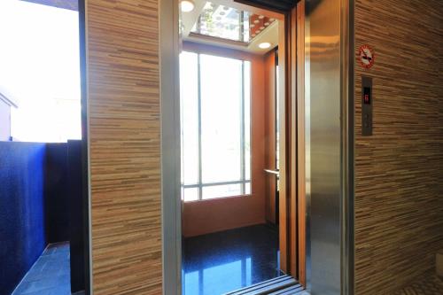 a door leading to a hallway with a window at Two Home Inn in Hualien City