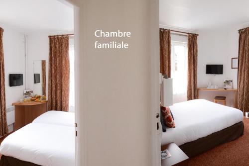 two beds in a hotel room with the words guarantee haunted at Hotel De Normandie in Arromanches-les-Bains