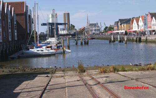 a boat is docked at a dock in a river at Ferienwohnung Ilsebill in Husum