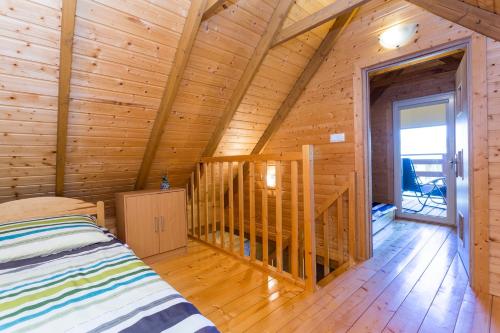 a bedroom with a bed in a log cabin at U Marleny in Ustka