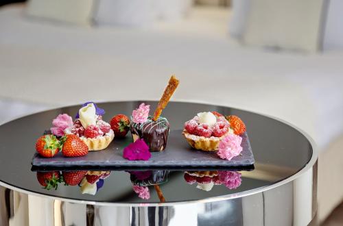 a plate of desserts with strawberries and ice cream at Meliá Milano in Milan
