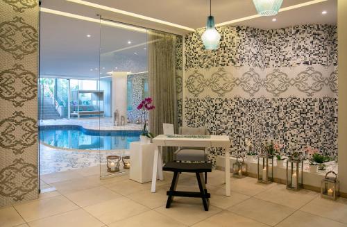 a bathroom with a table and a swimming pool at Vangelis Hotel & Suites in Protaras