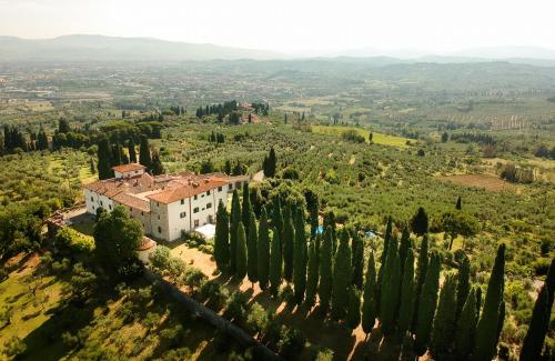 an aerial view of a building with cypress trees at Roveta Apartment in Scandicci