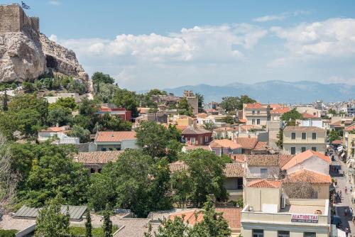 a cityscape of a town with a mountain at Splash of Glam II 10 Steps from Acropolis in Athens