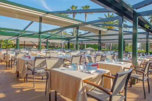 a row of tables and chairs in a pavilion at PortBlue Club Pollentia Resort & Spa in Alcudia