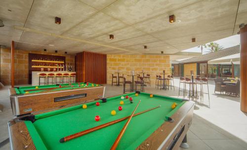 a pool table in a room with a bar at PortBlue Club Pollentia Resort & Spa in Alcudia