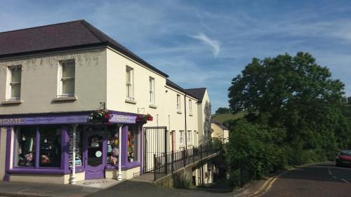 a building with purple trim on a street at 4 Bleach Green Apartments in Ballycastle