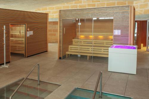 a room with a shower and a swimming pool at PortBlue Club Pollentia Resort & Spa in Alcudia