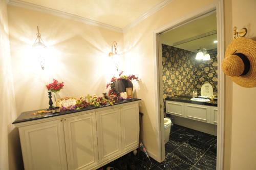 a bathroom with a sink and a toilet and a mirror at Joy House in Imari