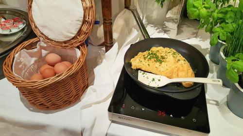a pan with some food in it next to a basket of eggs at Landgasthaus Bonn in Baunatal
