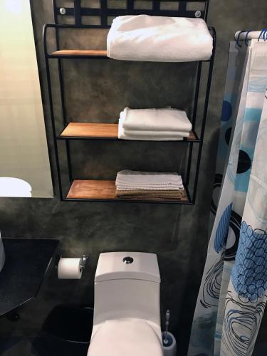 a small bathroom with a toilet and towels at Colonia Americana Two Level Loft in Guadalajara