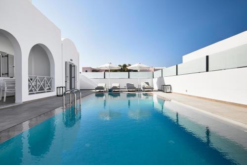 a swimming pool in the middle of a house at Tramonto Private Villa in Monolithos