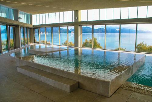 a large swimming pool in a building with windows at PortBlue Club Pollentia Resort & Spa in Alcudia