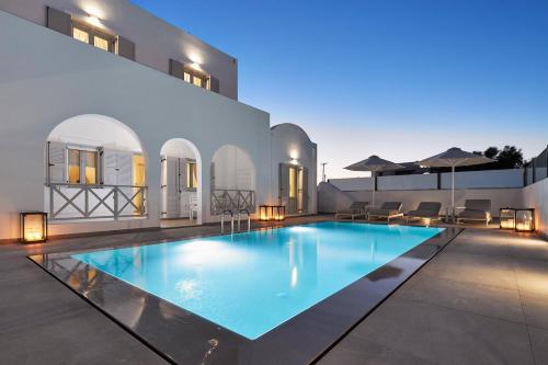 a swimming pool in the middle of a house at Tramonto Private Villa in Monolithos
