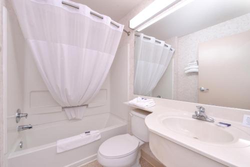 Baño blanco con lavabo y aseo en Americas Best Value Inn & Suites Maryville, en Maryville