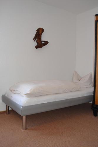 a bed in a room with a monkey on the wall at Hofreit am Bierkeller in Kehl am Rhein