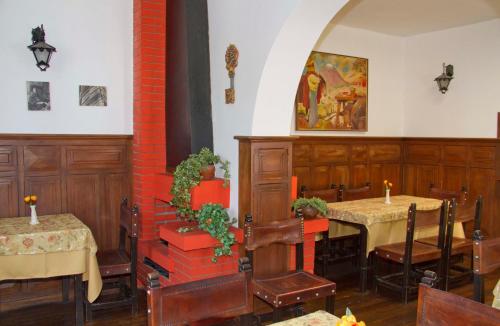 a dining room with two tables and a painting on the wall at Las Mercedes in Arequipa