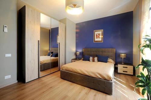 a bedroom with a large bed and a mirror at Casa Vacanze La Mattonara in Viterbo