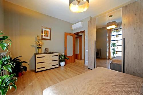 a bedroom with a bed and a dresser and a mirror at Casa Vacanze La Mattonara in Viterbo