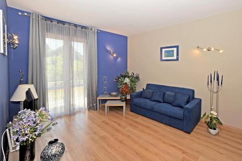 a living room with a blue couch and a table at Casa Vacanze La Mattonara in Viterbo