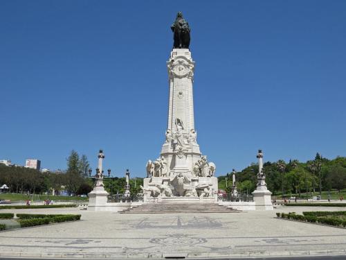 a monument with a clock on it in a park at Hotel 3K Madrid in Lisbon