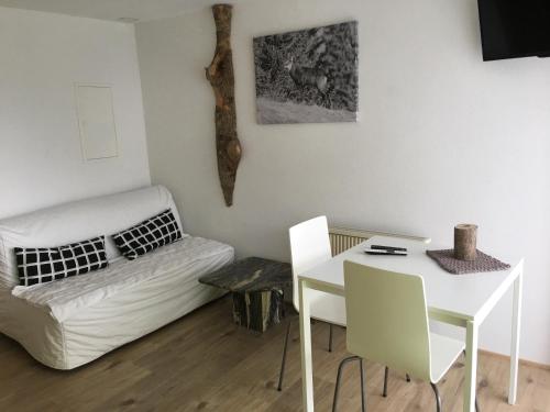 a living room with a white couch and a table at Christall in Andest