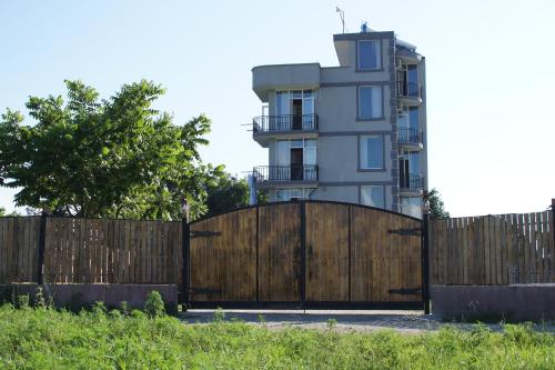 a wooden gate in front of a building at HOTEL Dadu in Batumi