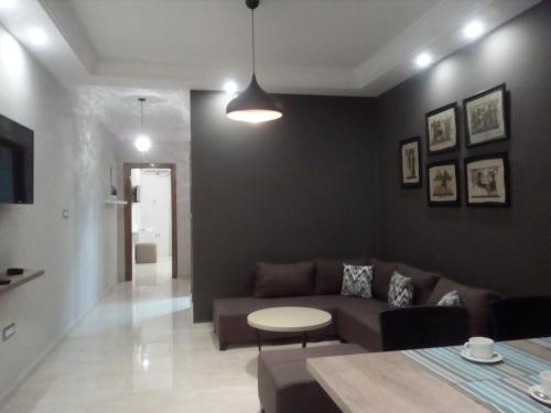 a living room with a couch and a table at London House in Bizerte
