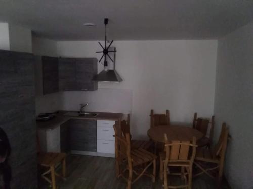 a kitchen and dining room with a table and chairs at Apartamenty Górskie LĄDEK-ZDRÓJ in Lądek-Zdrój